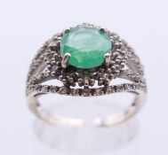 A 9 ct gold emerald and diamond ring. Ring size N.