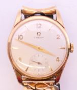 A boxed 9 ct gold Omega gentleman's wristwatch on associated strap, with Omega guarantee,