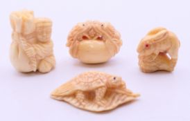 Four small bone carvings. The largest 4 cm long.
