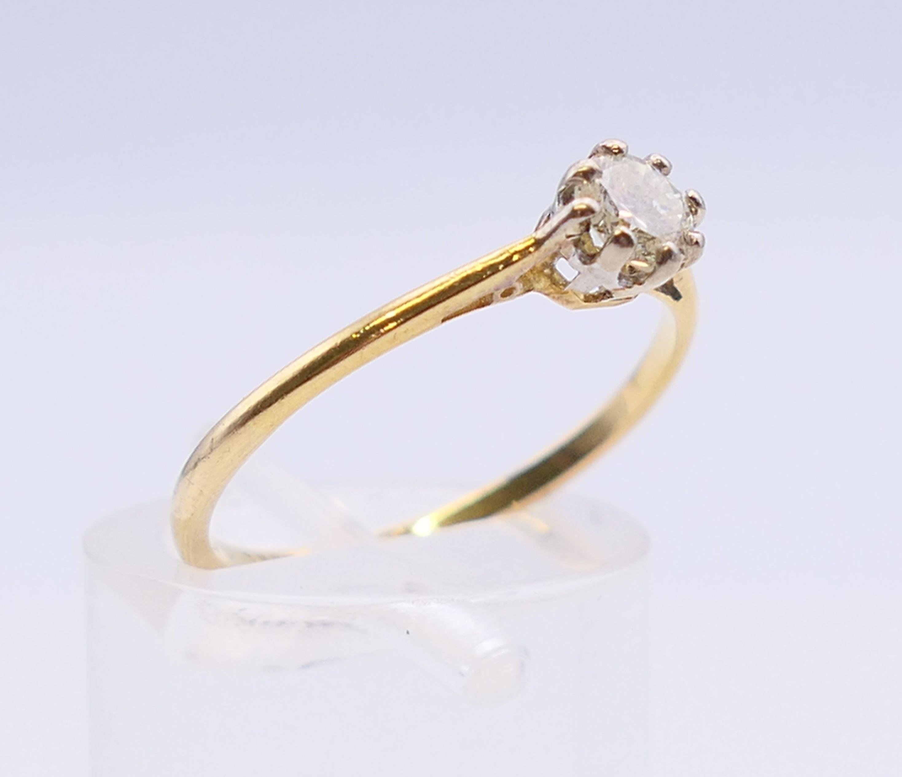 An 18 ct gold and platinum diamond solitaire ring. The claw set stone spreading to 0.25 carat. - Image 3 of 7