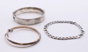 Two silver bangles and a silver bracelet. The bracelet 21 cm long. 35.6 grammes.