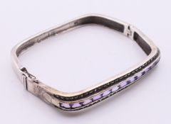 A silver marcasite and amethyst bracelet. 6 cm inner width.