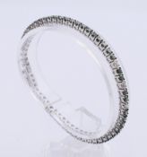 A colour-treated diamond bracelet designed as a brilliant-cut colour-treated 