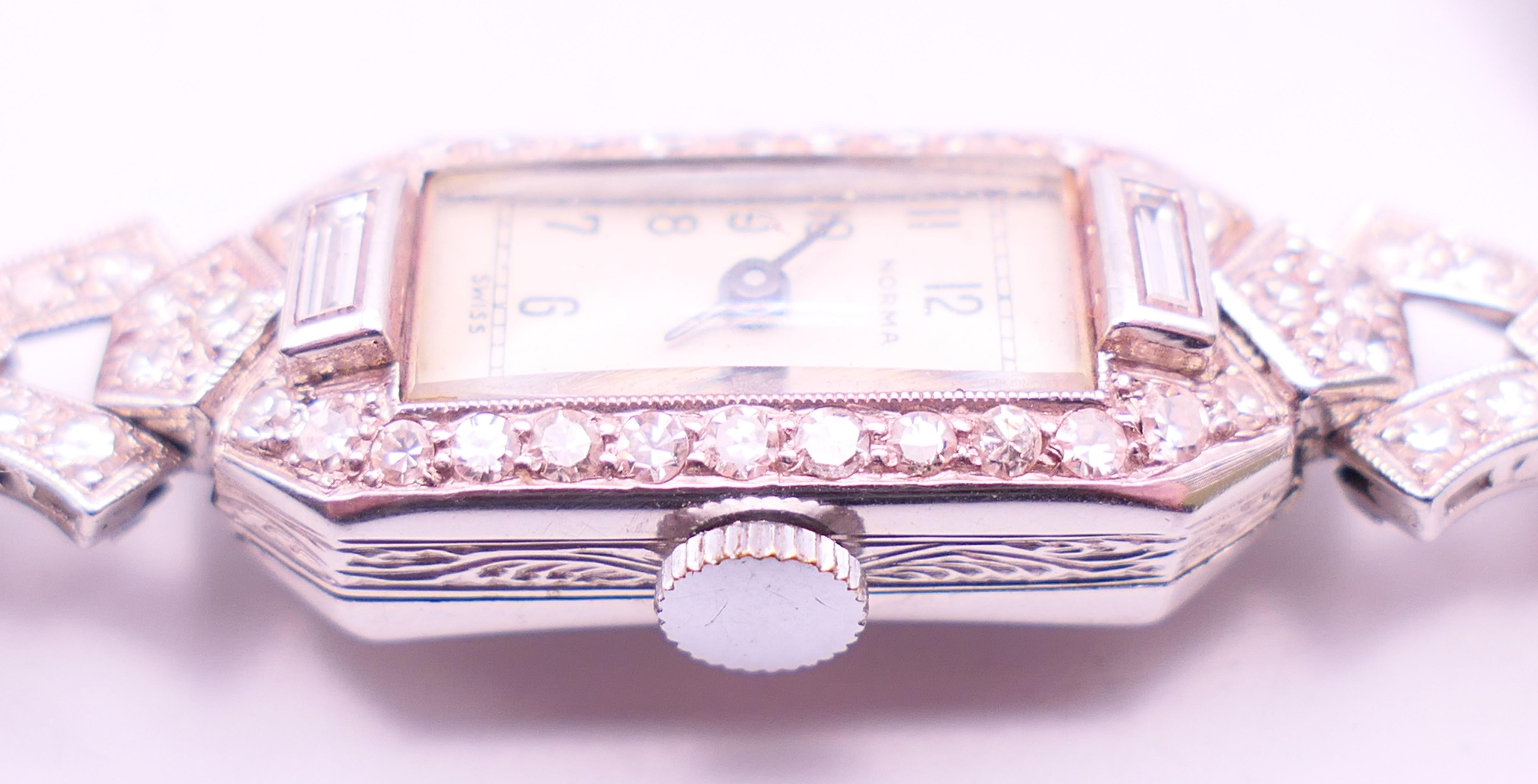 An early 20th century 9 ct white gold and diamond cocktail wristwatch and strap. 1.5 cm wide. - Image 4 of 6