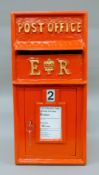 A red post box. 31 cm wide.