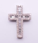 A diamond full set 18 ct white gold cross pendant, central princess cut diamond,