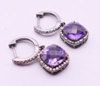A pair of diamond and amethyst earrings. The drops 1.2 cm high.