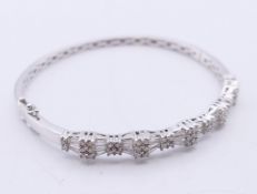 A 14 K white gold and diamond bangle-form bracelet. 6 cm inner diameter. 13.9 grammes total weight.