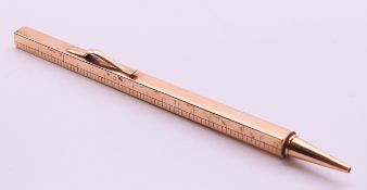 A 9 ct gold extending ruler pencil. 33 cm long extended. 25.7 grammes total weight.