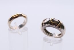 Two unmarked gold mounted silver rings. The largest ring size N/O, the other L.