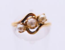 An unmarked gold and pearl ring. Ring size L.
