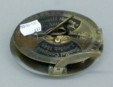 A brass oval sundial. 11 cm long.