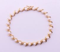 A 14 ct gold and pearl bracelet. 18 cm long. 10 grammes total weight.