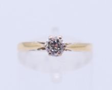An 18 ct gold diamond solitaire ring. Ring size N.