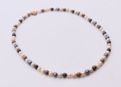 A multi-coloured pearl necklace, 40 cm long.