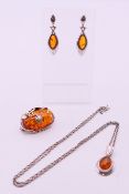Various dress jewellery items to include a brooch, a pendant on chain and a pair of earrings.