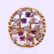 An 18 ct gold diamond and ruby ring. Ring size Q/R. 14.1 grammes total weight.