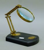 A magnifying glass on a stand. 12.5 cm wide.