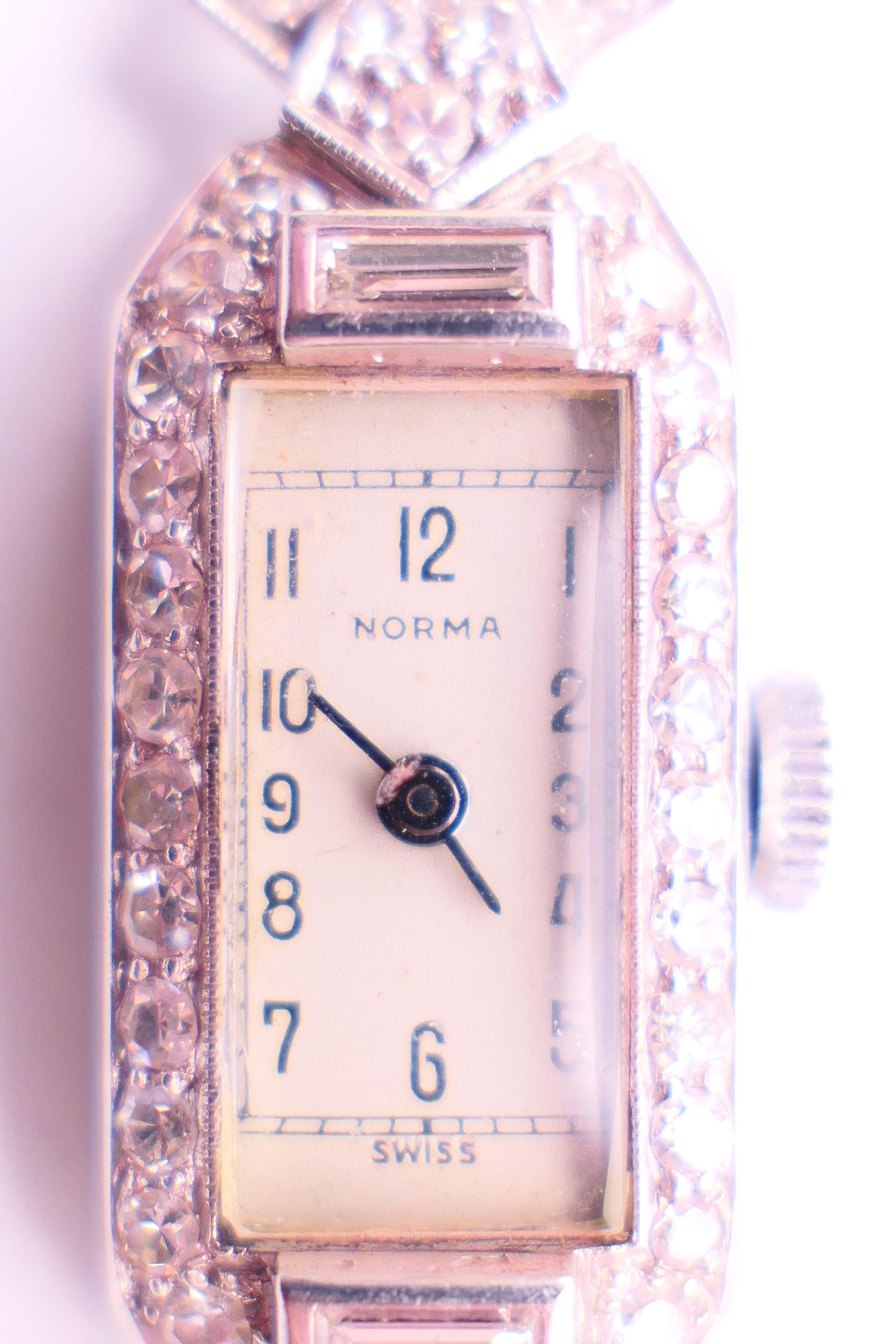 An early 20th century 9 ct white gold and diamond cocktail wristwatch and strap. 1.5 cm wide. - Image 2 of 6