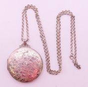 A silver locket, suspended from a chain, locket hallmarks for silver, chain stamped Sterling.