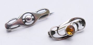 Two Charles Horner silver brooches. The largest 3 cm wide.