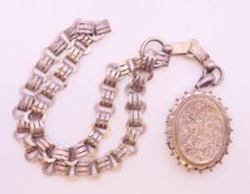 A Victorian silver locket on an engraved book chain necklace, hallmarked Birmingham 1881.