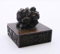 A Chinese bronze seal mounted with a dog-of-fo. 5.5 cm high.