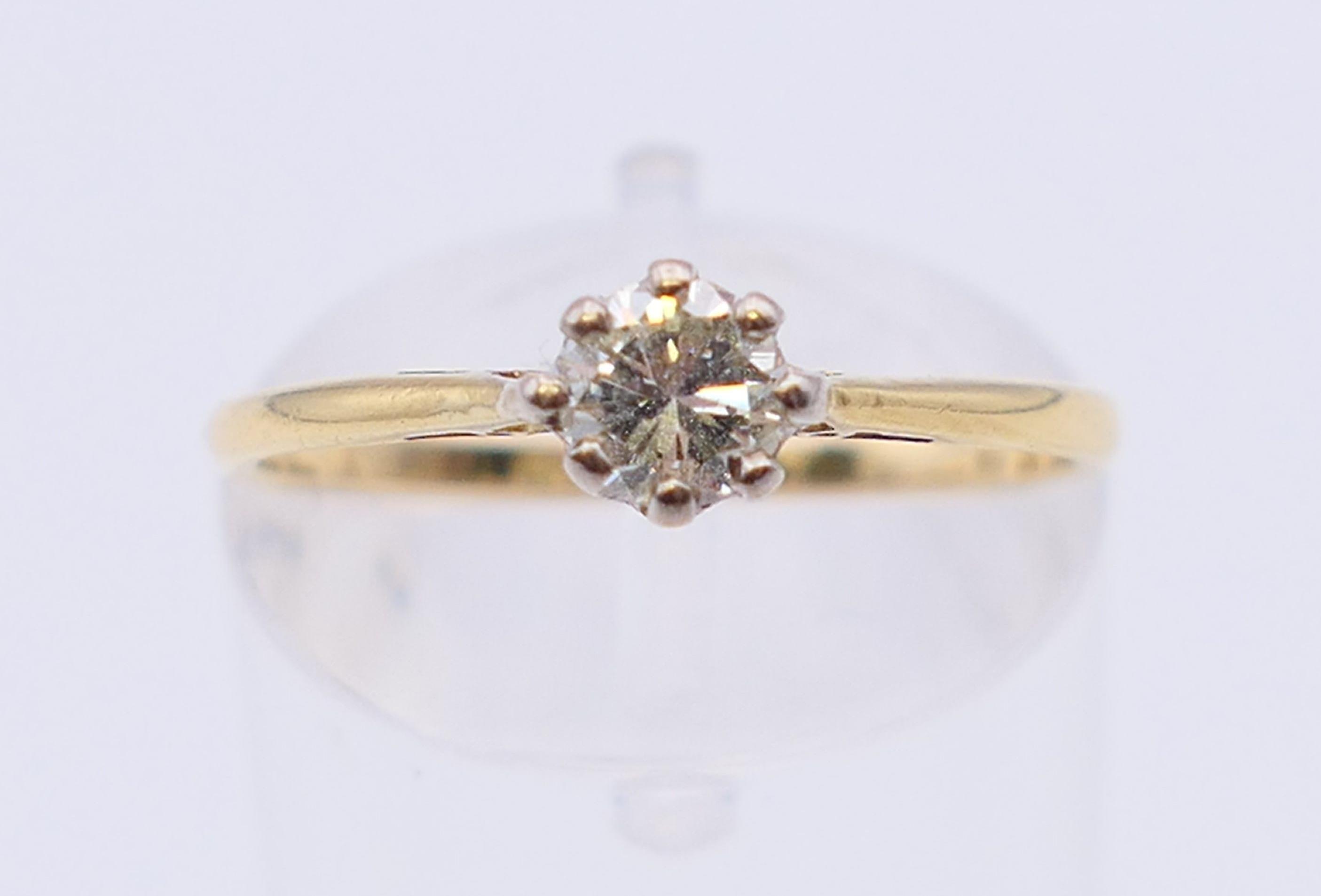 An 18 ct gold and platinum diamond solitaire ring. The claw set stone spreading to 0.25 carat. - Image 2 of 7