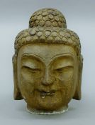 A stone Buddha head. 25 cm high.