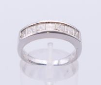 A platinum seven-stone diamond ring. Ring size L/M.