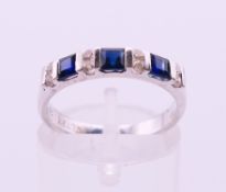 An 18 K white gold diamond and sapphire ring. Ring size L/M.
