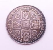 A George II silver coin. 2.5 cm diameter.