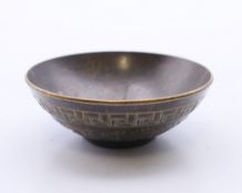 A small Chinese bronze bowl. 6 cm diameter.