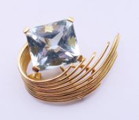 A mid-20th century aquamarine brooch, the rectangular-shape aquamarine, to the graduated bar scroll,