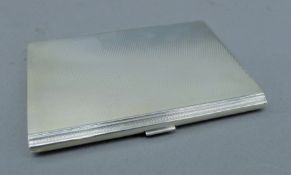 A silver cigarette case. 11.5 cm wide. 189.2 grammes.