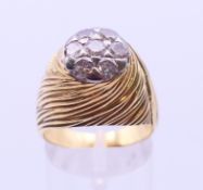 An 18 ct gold diamond cluster ring. Ring size Q. 10.6 grammes total weight.