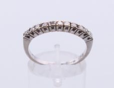 An 18 ct white gold eleven-stone diamond ring. Ring size Q.