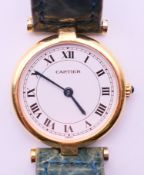 A boxed 18 K gold ladies' Cartier wristwatch. 2.5 cm wide.