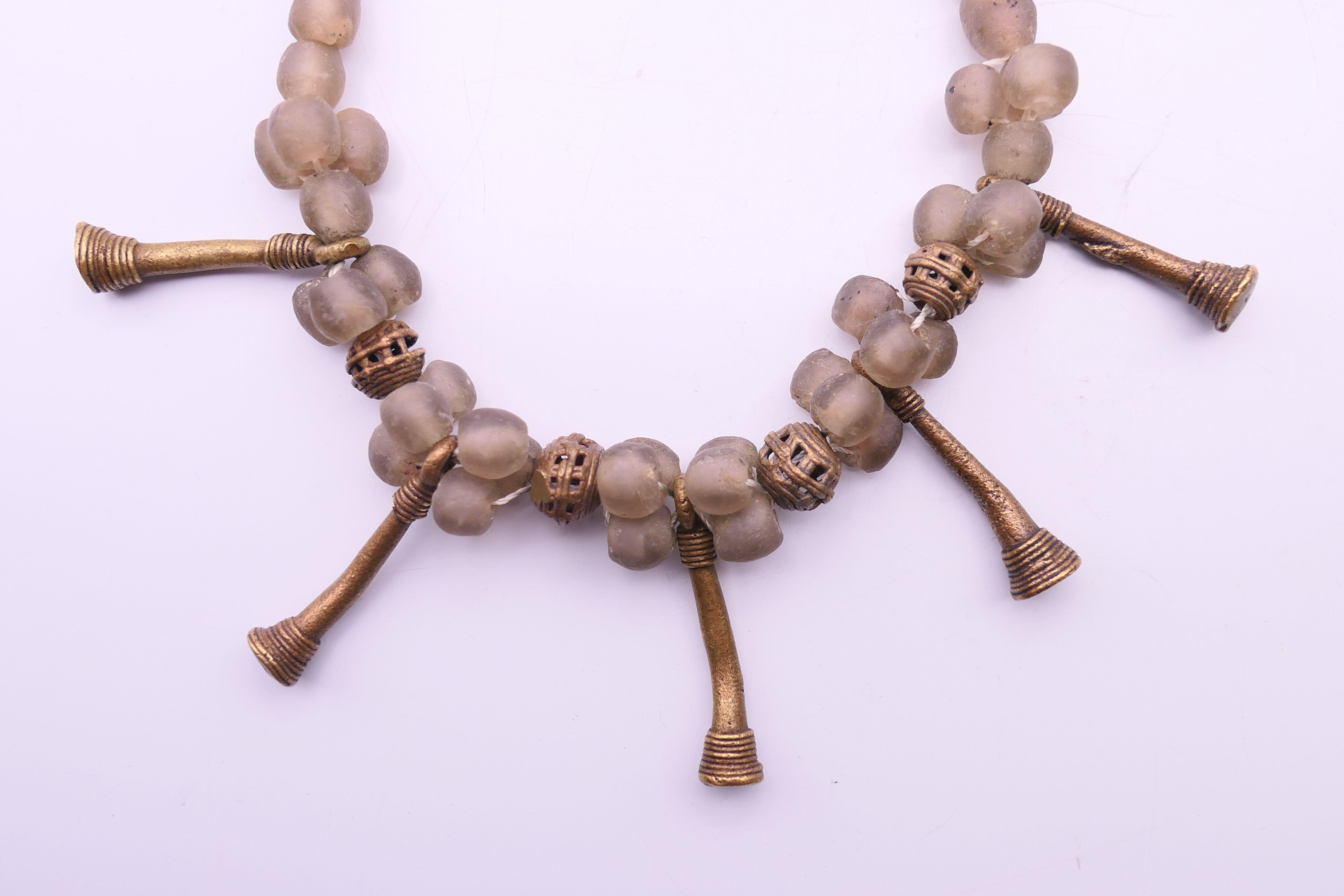 An Ethnic rock crystal necklace, a mixed metal necklace and a pendant. The former 45 cm long. - Image 3 of 7