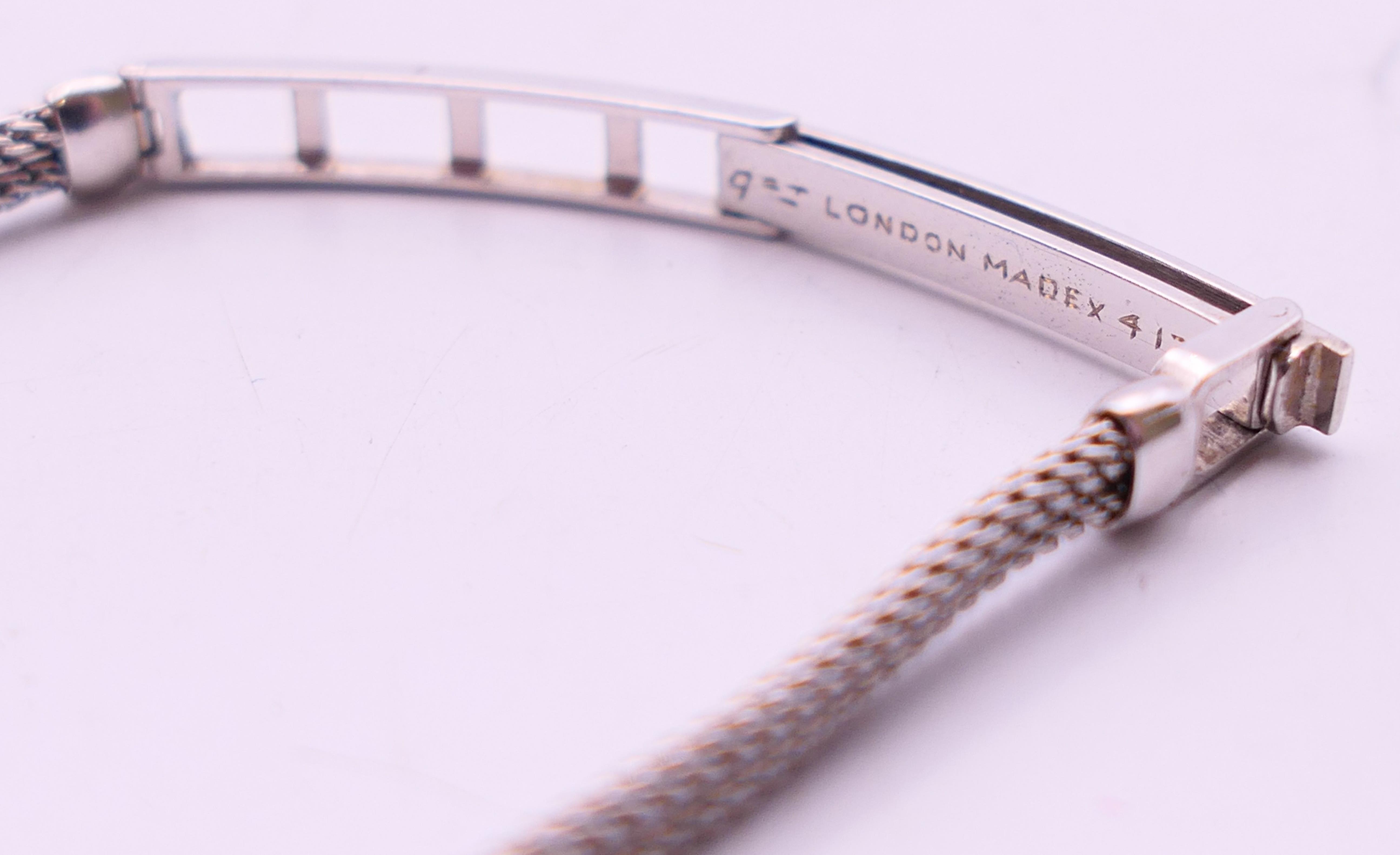 An early 20th century 9 ct white gold and diamond cocktail wristwatch and strap. 1.5 cm wide. - Image 6 of 6