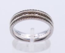 An 18 K white gold eternity ring. Ring size O.