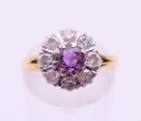 An 18 ct gold diamond and ruby flowerhead ring. Ring size L/M.