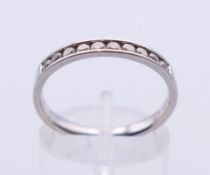 A platinum channel set diamond ring. Ring size O.