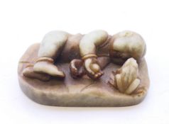 A Russian hardstone carving of a boy and a frog,