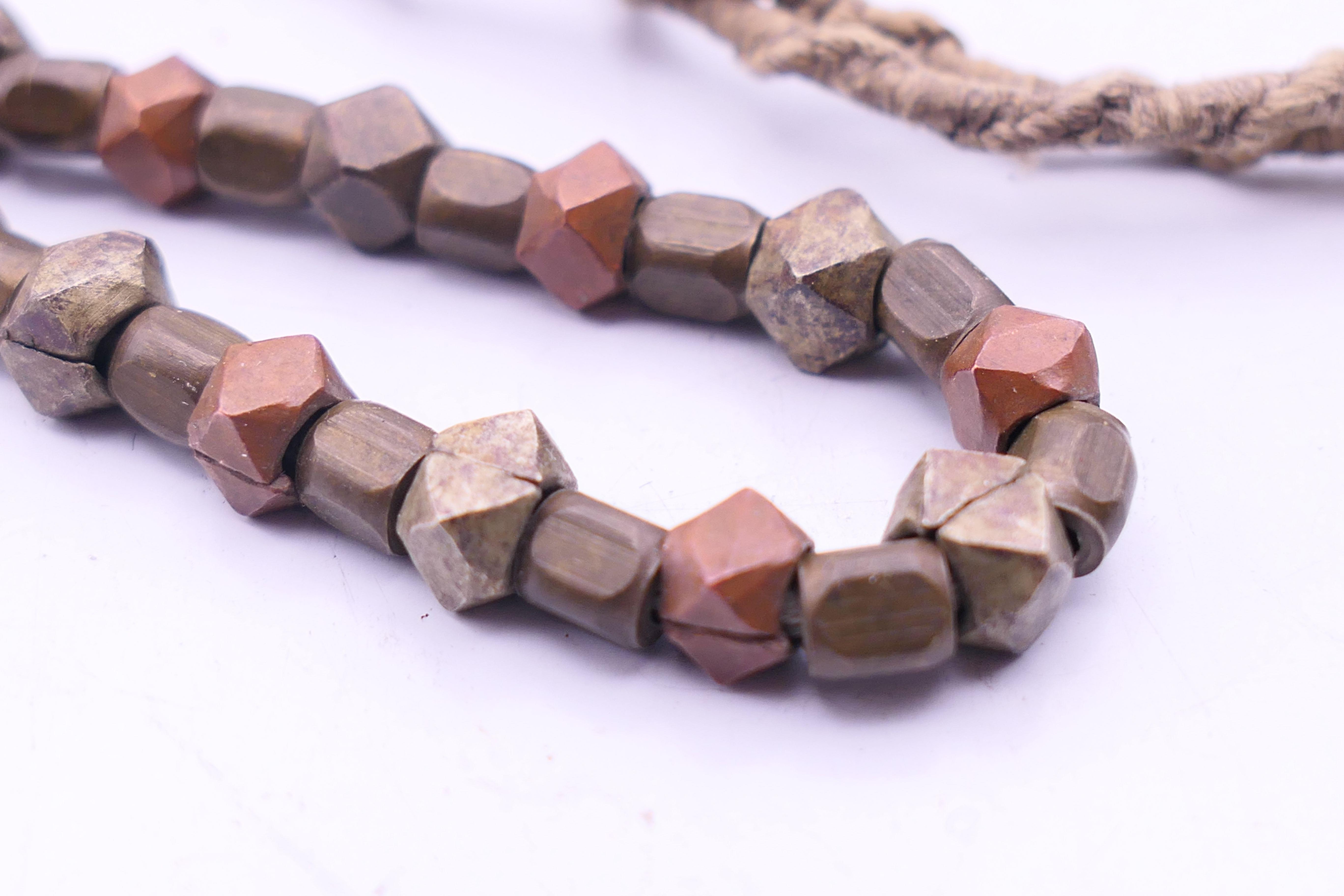 An Ethnic rock crystal necklace, a mixed metal necklace and a pendant. The former 45 cm long. - Image 7 of 7