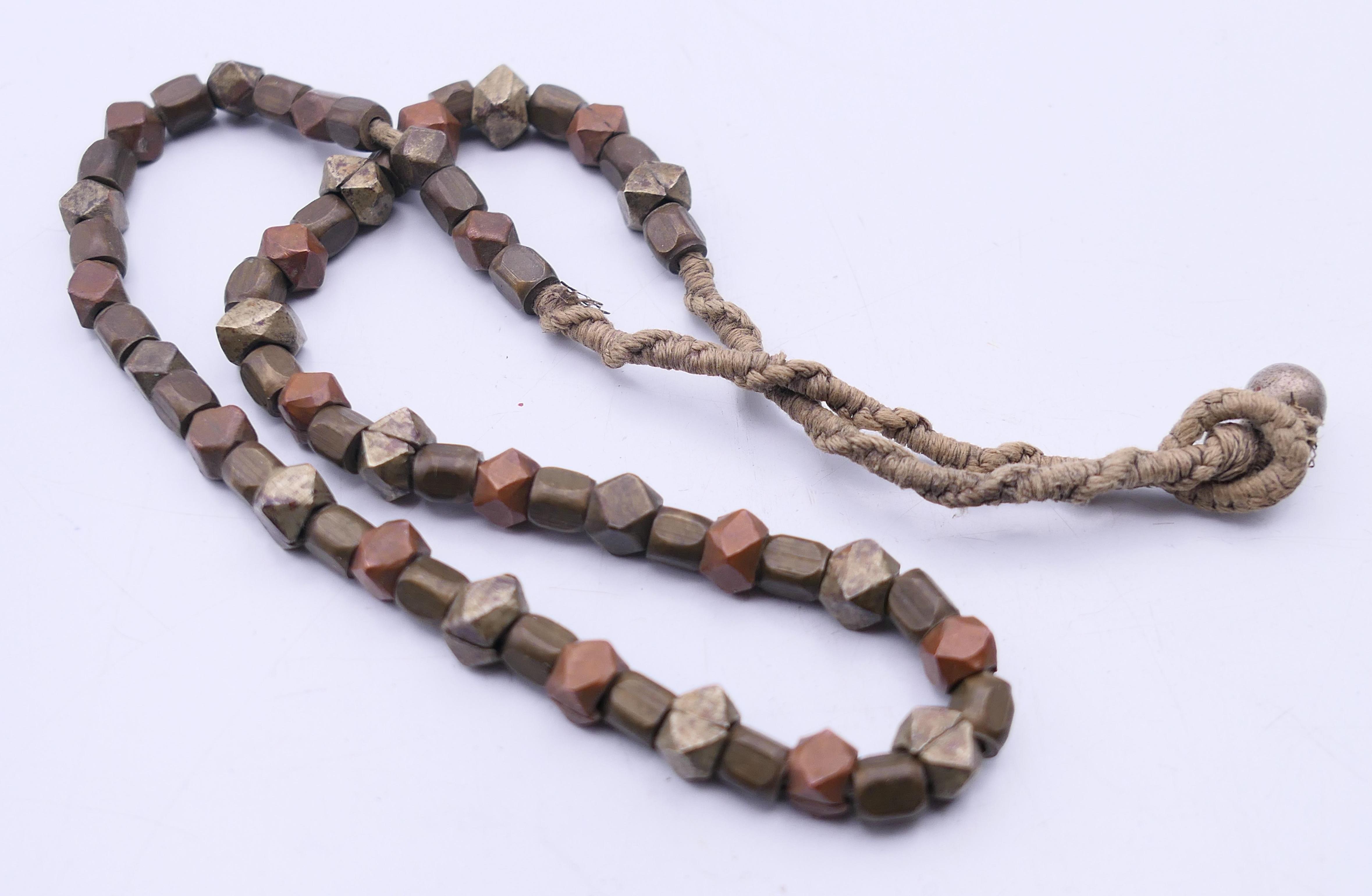 An Ethnic rock crystal necklace, a mixed metal necklace and a pendant. The former 45 cm long. - Image 6 of 7