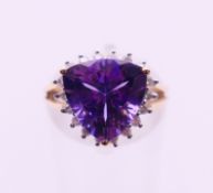 A 9 K gold amethyst and diamond ring. Ring size I/J.