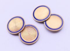 A pair of 14 ct gold cuff links set with a ring of blue enamel,
