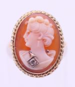 A gold diamond set cameo ring. Ring size I.