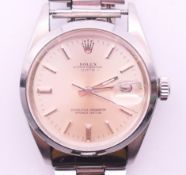 A gentleman's stainless steel Rolex Oyster Perpetual Date wristwatch. 3.5 cm diameter.